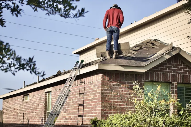 Professional roofer working on a residential roof in Sandpiper Village